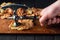 The chef beats off raw veal with meat tenderizer. Close-up of the work environment and the hands of the chef on the kitchen table