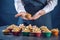 Chef in a black apron holding the fresh baked muffins in hands. Concept of confectionery cooking