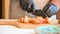 Chef in black gloves cuts tomatoes on the cutting board