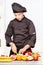 Chef in black uniform cutting fruit