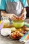 Chef boy cooking on a Easter kitchen table and cooking dough.