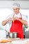 Chef Breaking Egg In Mixing Bowl While Preparing