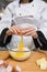 Chef breaking eggs into flour