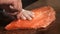 Chef carves the fresh salmon in restaurant