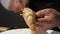 Chef is carving giant river prawns with his bare hands and kitchen knife.