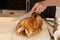 A chef carving roast turkey in a live display