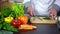 Chef chopping dill on board in kitchen