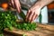 Chef chopping fresh green parsley. Generative AI