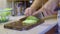 Chef chopping lettuce rapidly at home kitchen