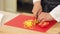 Chef is chopping red and yellow paprika