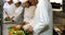 Chef chopping vegetables on green board