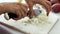 Chef chopping white onion on marble cutting board, close up accelerated video