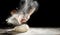 Chef clapping his hands to dust dough with flour