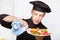 Chef cleaning edge of a fruit plate with cloth