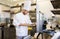 Chef with clipboard doing inventory at kitchen