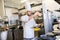 Chef with clipboard doing inventory at kitchen