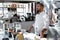 The chef conducts a master class in cooking. On the background is kitchen utensils, on the table in front of him vegetables in