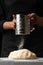 Chef cook baker sprinkles flour on a dough for cooking pastries, bread and pizza. Recipes and home cooking. Baking Recipe Book,