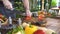 Chef cook cutting with knife tomato on food composition background. Man with knife slicing fresh tomato on kitchen table