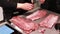 Chef cook explains how to cut meat rib eye for steaks. Fillet raw meat cutting, food master class