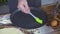 Chef cook pouring olive oil on baking tray and spreading with brush on kitchen table. Olive oil for baking pie, cake