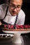 Chef cook preparing tart in his kitchen. Delicious raspberry  tart tartlet with whipped cream.