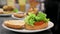 Chef cooking burger, putting meat chop on lettuce close-up, making sandwich, fast food concept, recipe of preparing