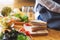 A chef cooking whole wheat sandwich and vegetables salad in kitchen