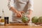 Chef cooks artichoke y slicing it on a light background, concept cooking tasty and healthy food, menu, recipe book, detox,