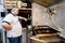 Chef cooks piece of meat on plate and takes ready