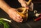 Chef crushing a blending garlic in a wooden pestle and mortar in a close up view on his hands. Cooking a national dish in the