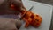 Chef cuts carrots with a knife on a cutting board