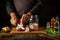 The chef cuts the fish into steaks before preparing the herring in a jar. Work environment on the kitchen table with aromatic