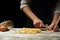 The chef cuts Italian pasta from dough. Against a dark background. A concept of preparing delicious food, Italian cuisine and