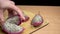 Chef Cuts Pitahaya on Wooden Table board on black background. Fresh sweet tropical organic piece of dragon fruit, exotic ripe juic