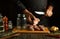 The chef cuts raw fish into steaks before preparing herring in a jar. Working environment on the kitchen table with aromatic