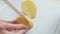 The chef cuts the young potatoes into slices on a beige kitchen board close-up.