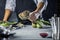 Chef cutting artichokes for dinner preparation - Man cooking inside restaurant kitchen
