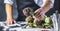 Chef cutting artichokes for dinner preparation - Man cooking inside restaurant kitchen