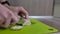 Chef cutting boiled chicken breast with knife