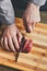 Chef cutting filet mignon on wooden board at restaurant kitchen