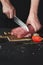 Chef cutting filet mignon on wooden board at restaurant kitchen