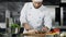 Chef cutting pork fillet at kitchen. Man chef preparing meat in slow motion