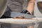 chef cutting sweet chocolate bars with caramel filling , fudge candy for cheesecake preparation