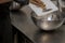 chef cutting sweet chocolate bars with caramel filling , fudge candy for cheesecake preparation