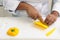 Chef cutting yellow pepper