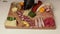 The chef decorates the ?harcuterie and cheese platter. Appetizers boards with assorted cheese, meat, grape and nuts. Speed Motion