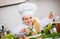 Chef decorating plate of salad with cheese and smiling