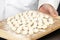 Chef Displaying Gnocchi on Cutting Board