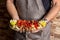 Chef displaying a plate of freshly cooked meat with peppers and lemons